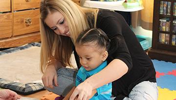 Child sitting in person's lap